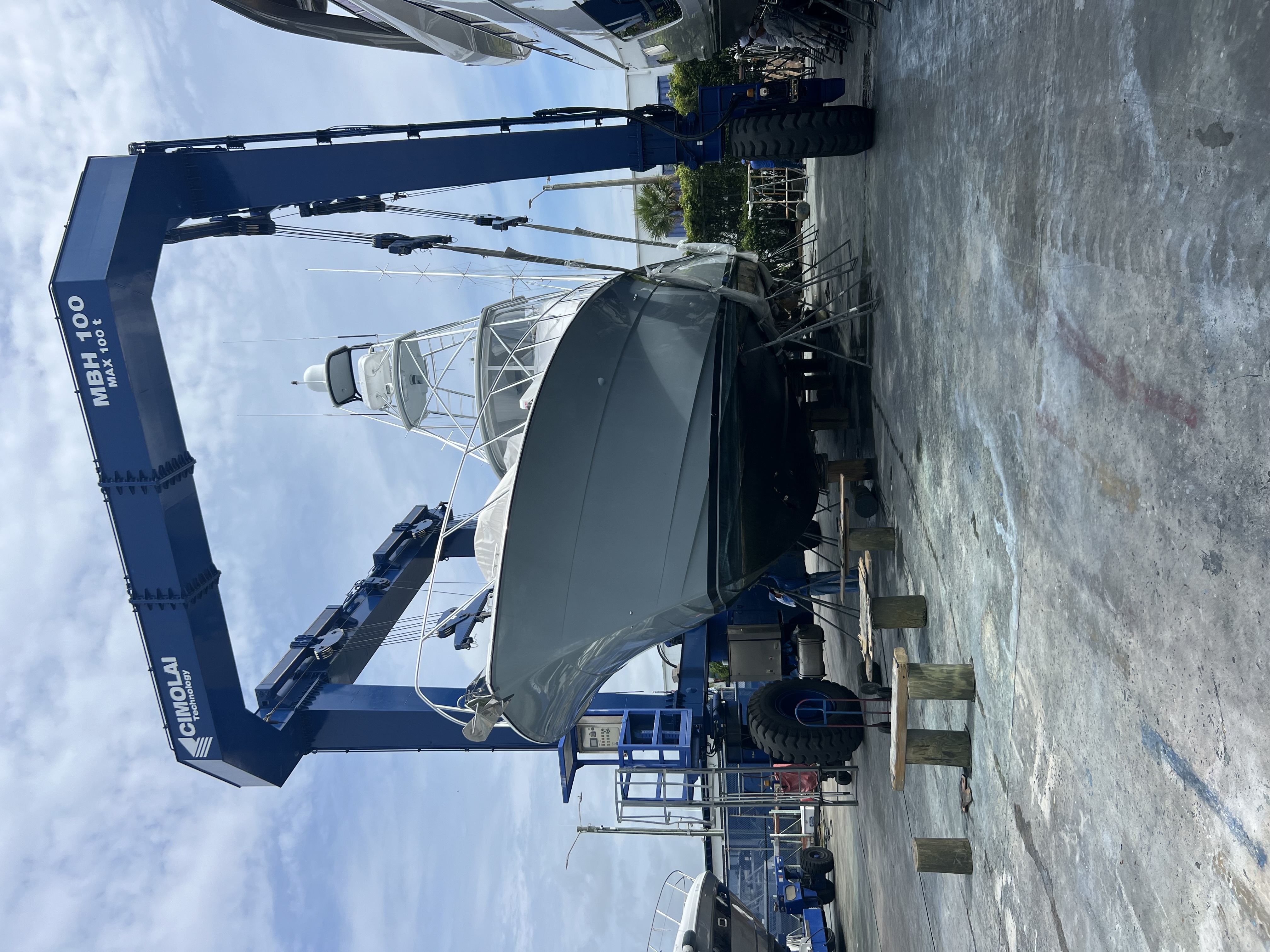 Sportfish yacht lifted by crane for yard work and delivery